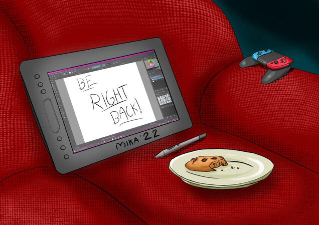 A graphics tablet that says "Be Right Back!", a cookie on a plate, and a Nintendo Switch controller sitting on a couch A graphics tablet that says "Be Right Back!", a cookie on a plate, and a Nintendo Switch controller sitting on a couch